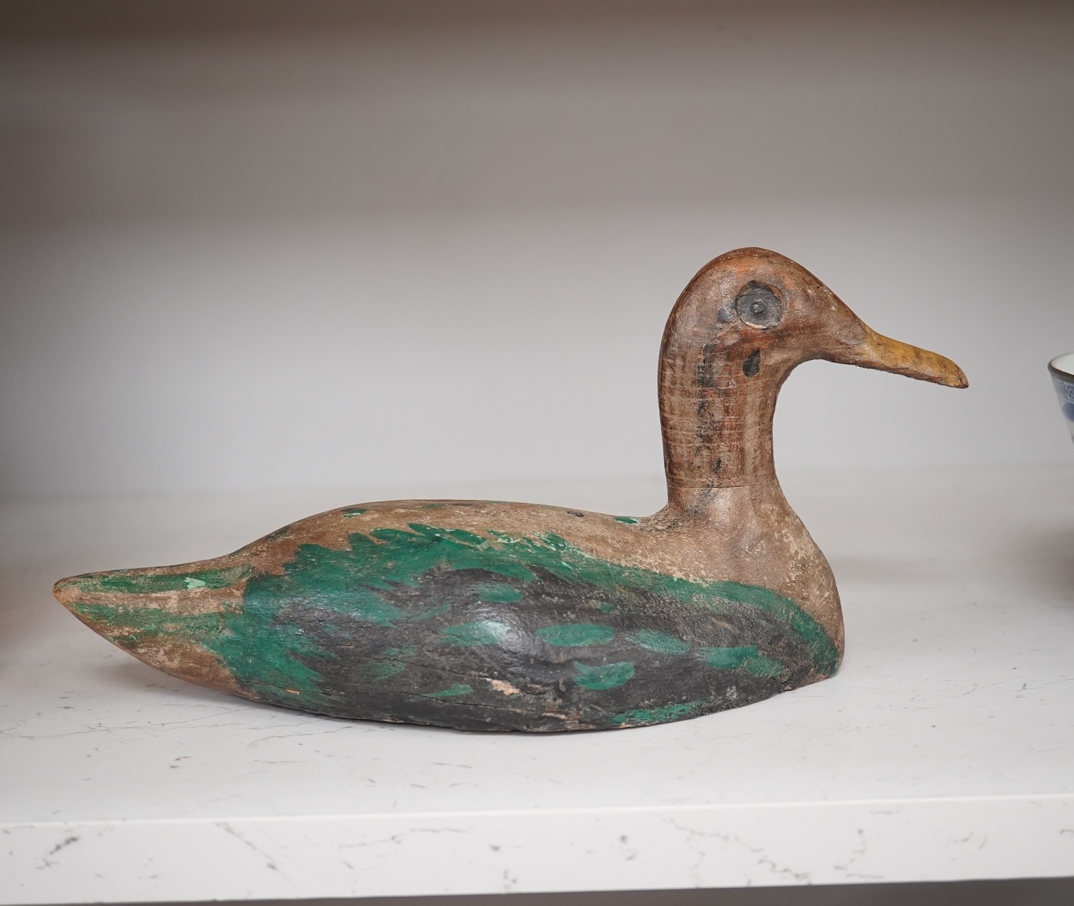 A 19th century painted decoy duck, 31cm long. Condition - worn